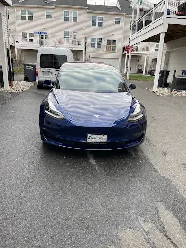 Blue Tesla front view with glossy protected paint on a Northern Virginia driveway